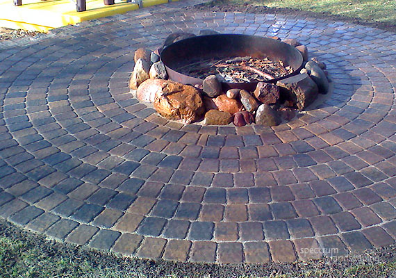 circular firepit by Spectrum Landscaping, Inc