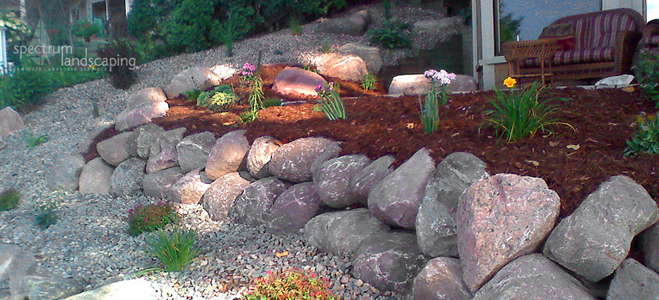 Spectrum Landscaping - bolder wall with softscapes